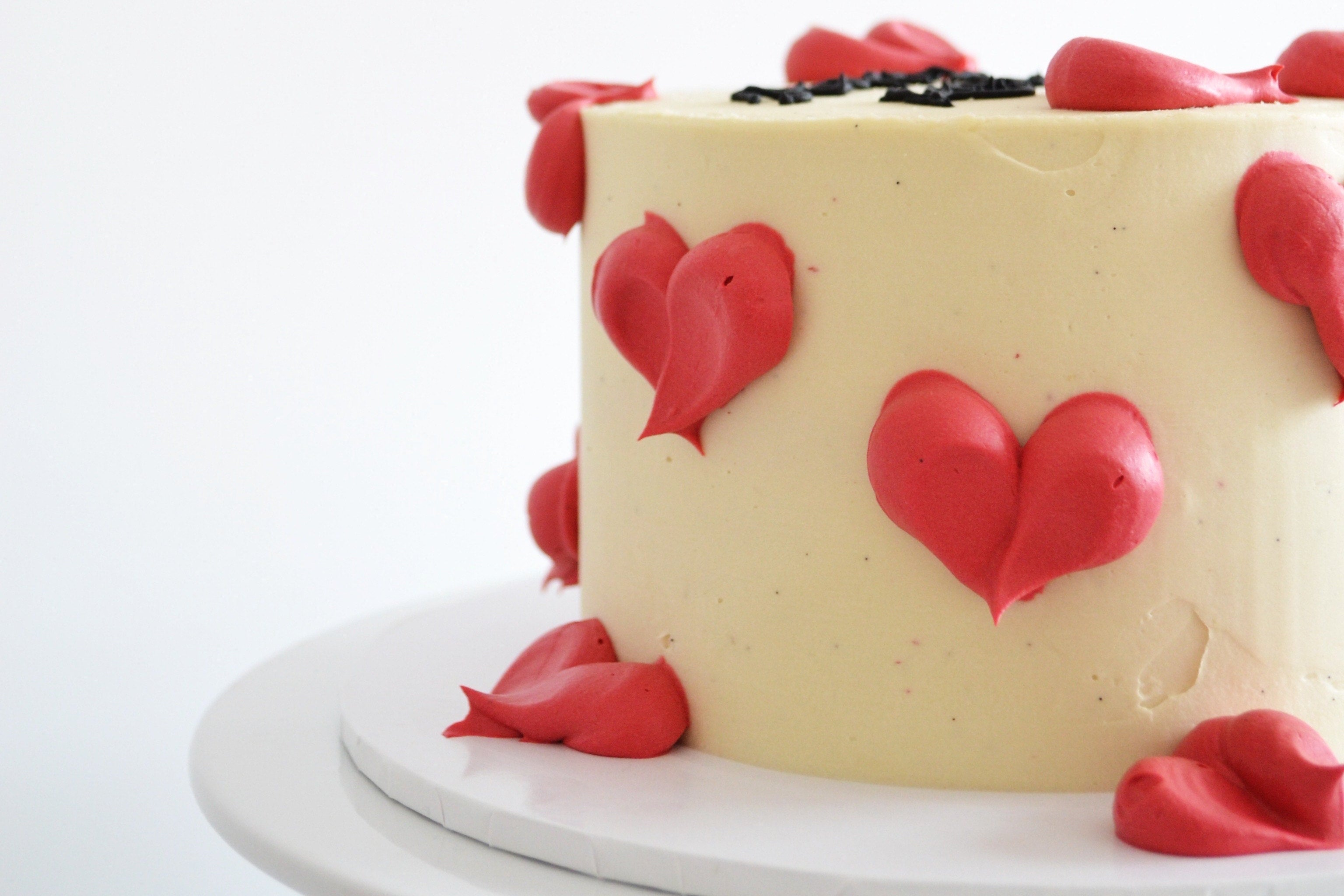 Cake with red heart decorations on a white background